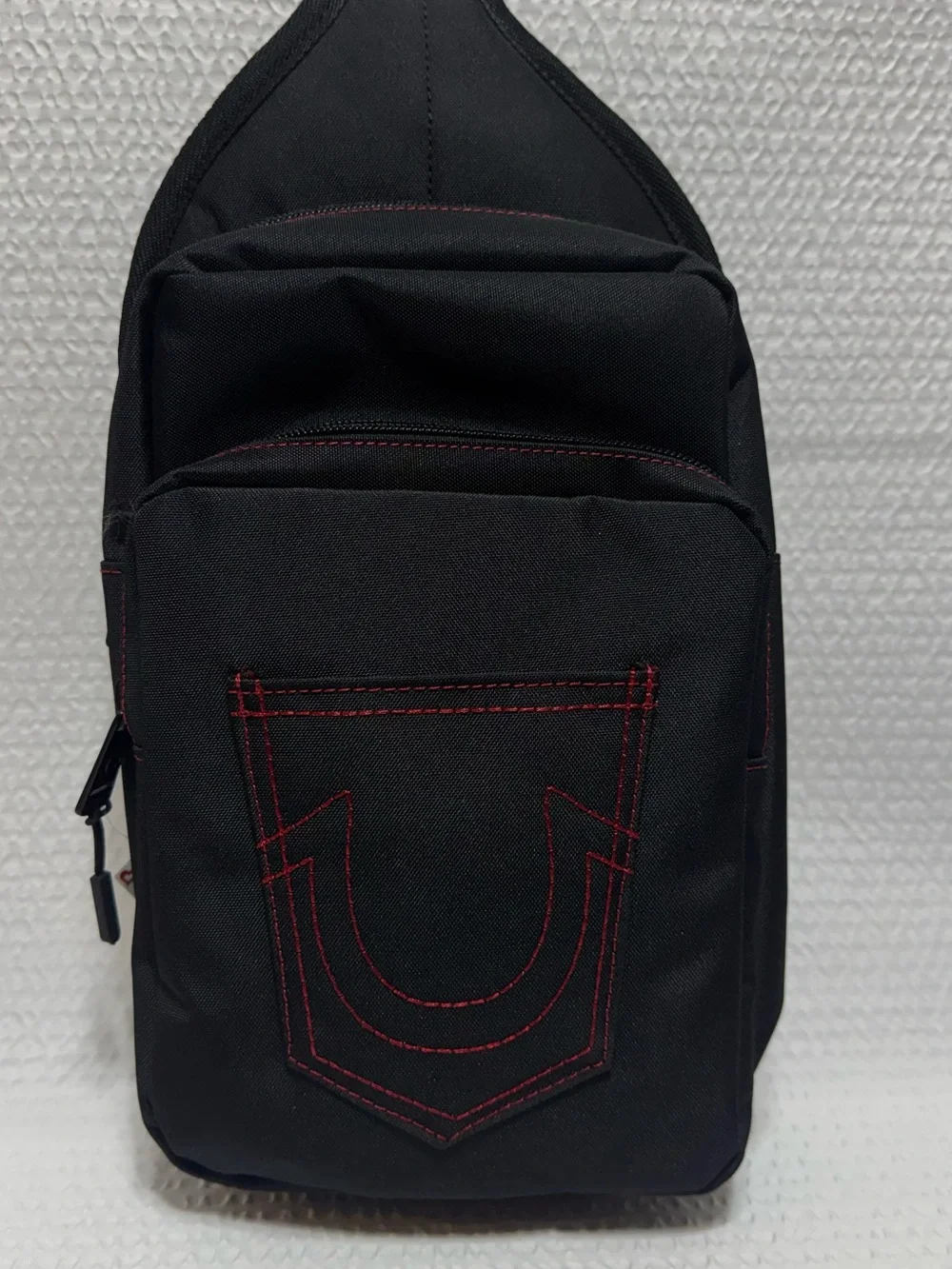True religion travel sling black bag red horseshoe front